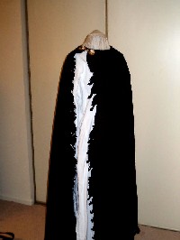 cloak closed over shoulder